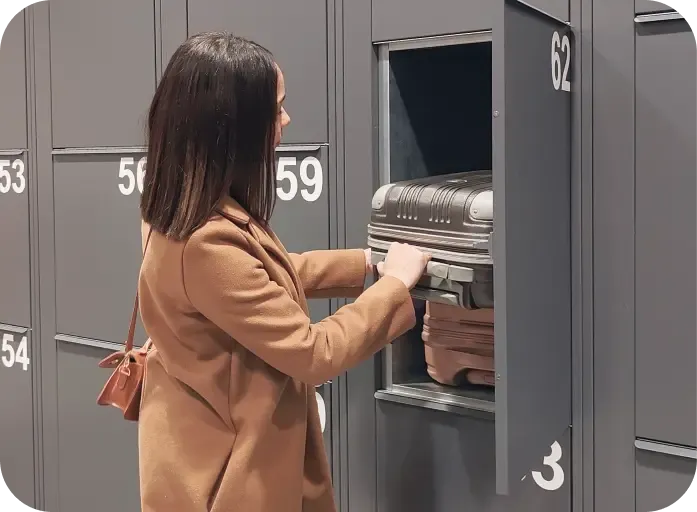Woman storing her suitcases in a locker